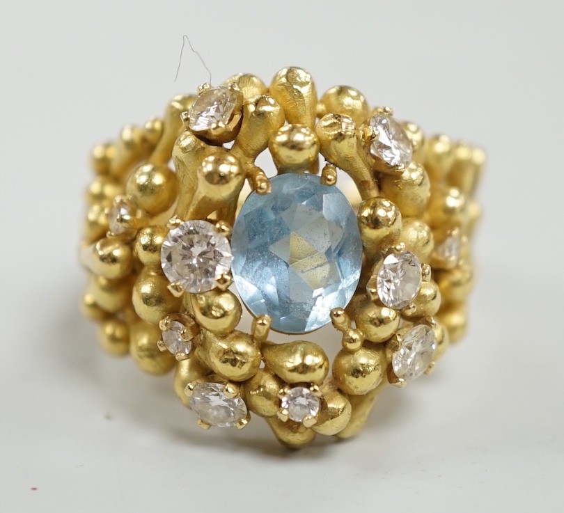 An early 1970's modernist 18ct gold, aquamarine and diamond cluster set dress ring, maker HB or AB? in italics, size O/P, gross weight 16.8 grams.